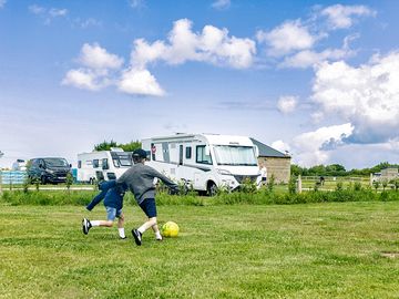 Large grass touring pitch with electric