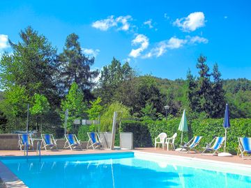 Swimming pool with deck chairs