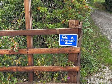 The berries camping sign on sandy lane