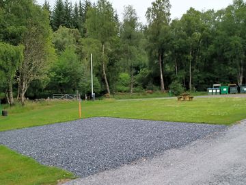 Hardstanding pitch with grass to the side