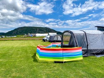Visitor image of the field and the pub in the background