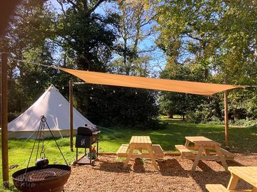 Communal area with waterproof sail for cooking and relaxing