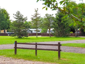 Gravel pitch with grass and electric