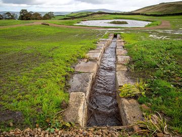 Stone waterfall leading to a lake