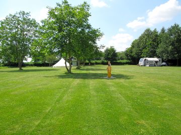The bell tent is set up on our large camping field
