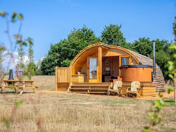 Cabin with seating and a woodfired hot tub