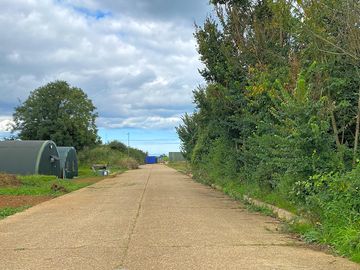 Parking is past the two Nissan huts