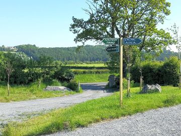 Entrance and pathways with a view of the hill of dowth in the background