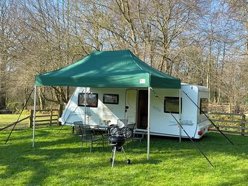 Covered seating area with garden furniture and barbeque are also provided.