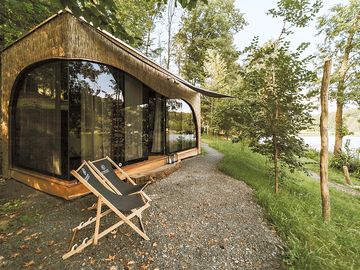 Relaxation infront of a glass-wooden house
