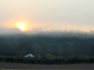 Situated on a farm with woodland behind