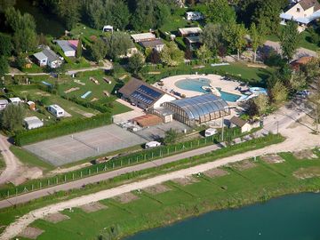 Drone view of the indoor and outdoor pool as well as the tennis court