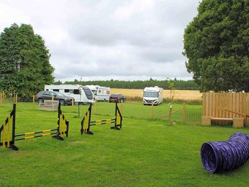 Dog park with dog agility equipment for use by campers and their dogs