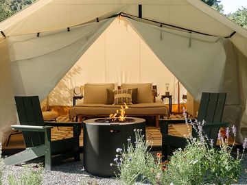 Glamping tent with a firepit and outdoor seating