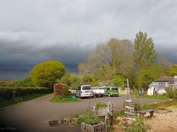 Car park and drive with a stormy backdrop.