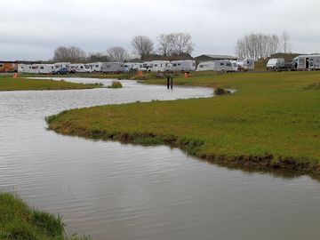 Scenic location with fishing lake next to pitches