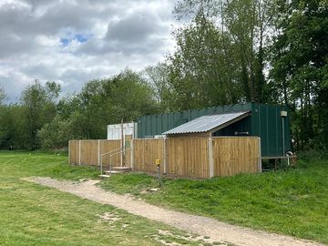 Toilets, showers & washing up sink within fenced compound