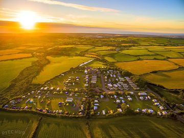 Aerial view of the site out to sea with a great sunset