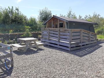 Exterior of the Robin's Nest has a picnic table and a barbecue area