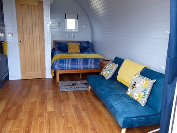 Sofa pulls out into a small double bed giving space for a third guest.