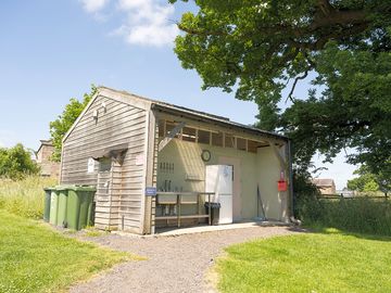 Toilets, showers and outside washing up area with fridge and freezer