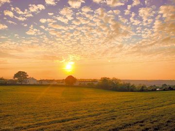 Visitor image of the sunset view overlooking the field next to pitch