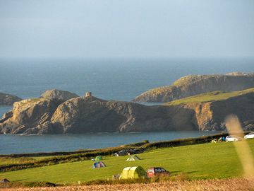 Campsite pitches with coastal backdrop