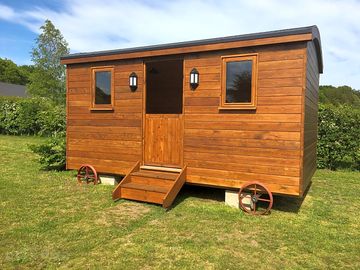 Shepherd's hut with the top half of the door opened