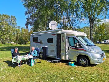 Caravan open pitch - sunny and grassy.