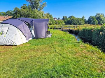 Visitor image of the massive tent set up next to the river