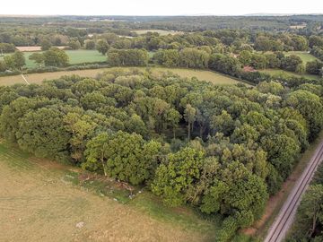 Aerial view over wild boar wood campsite, with the bluebell railway running alongside