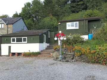 The lodges are nestled in woodland on a quiet hillside on the edge of the village of Cynwyd