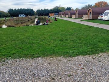 Our lakeside glamping pods and grass pitches
