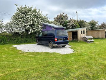 Gravel and grass pitch with shelter and seating