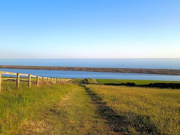 Farm walk towards the coast path along the fleet nature reserve skylarks singing in the background.