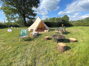 Typical Bell Tent set up including outside seating area and firepit