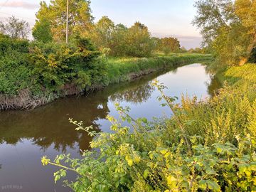 Peaceful river brue running along the edge of the campsite