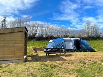Ready tent with picnic table and private kitchen area.
