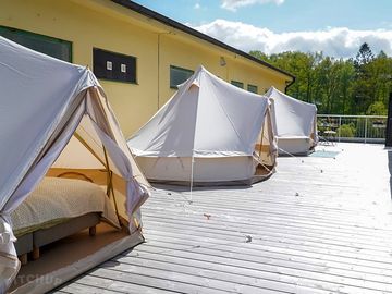 Bell tents on a wooden deck