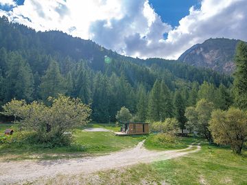 Pitches backed by forest and mountains