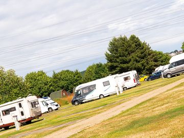 Main touring field with hardstanding pitches and electric hook up