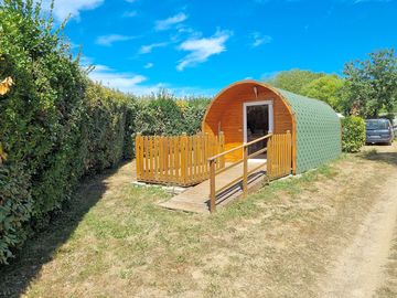 Camping pod with a fence