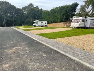 Gravel pitches with water, electric and drain.