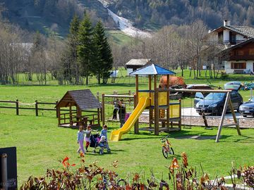 Younger visitors in the playground, surrounded by nature