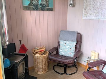 Seating area in the hut with a log burner