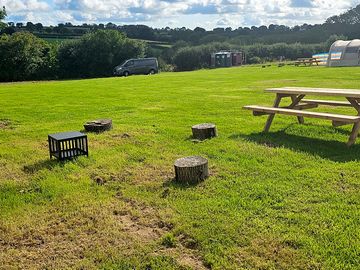 Each wild camping pitch has its own table, fire pit and log seats