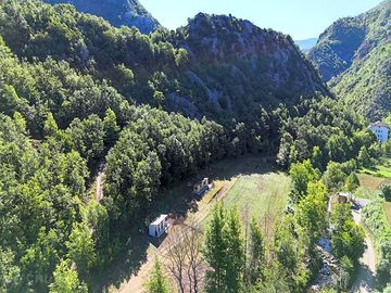 Pitches surrounded by forested mountains