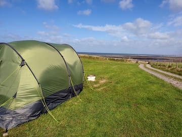 Tent pitch with sea in the background
