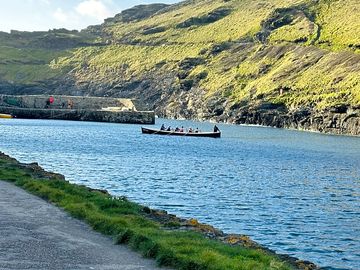 Boscastle harbour with the gig boat going out