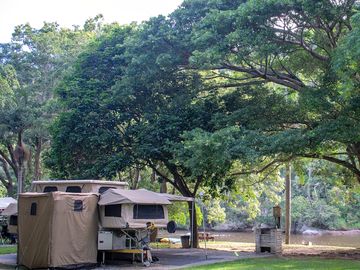 Riverside campsite tucked among trees